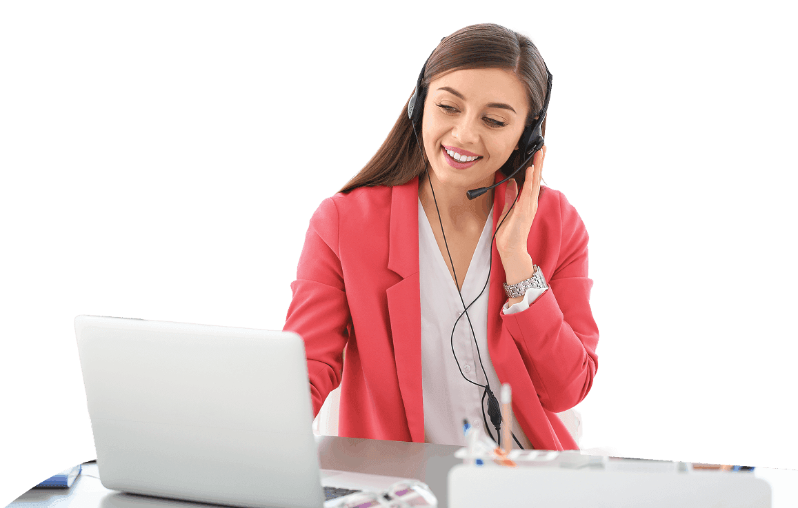 A woman wearing a headset smiling at a laptop on her desk.